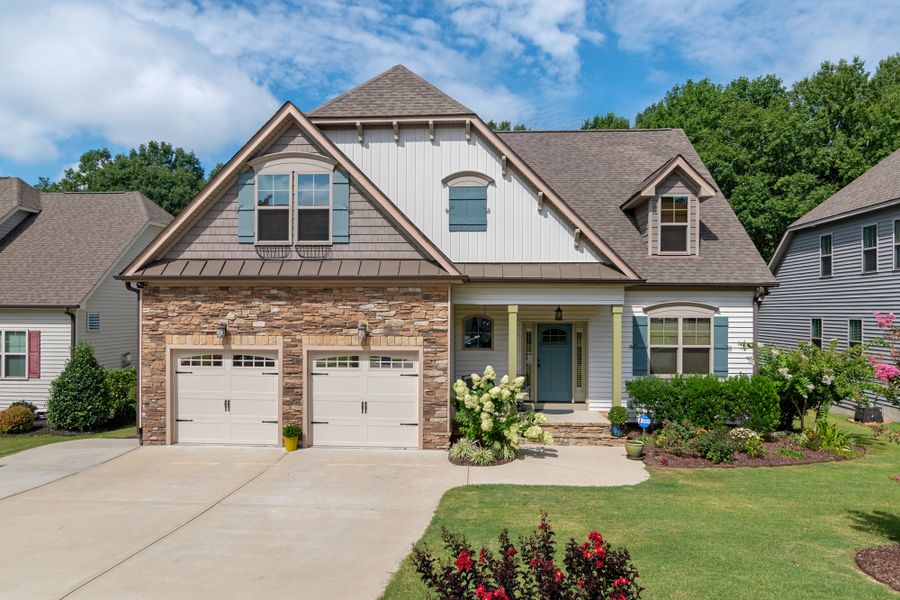 Two-story suburban house with a double garage and front garden